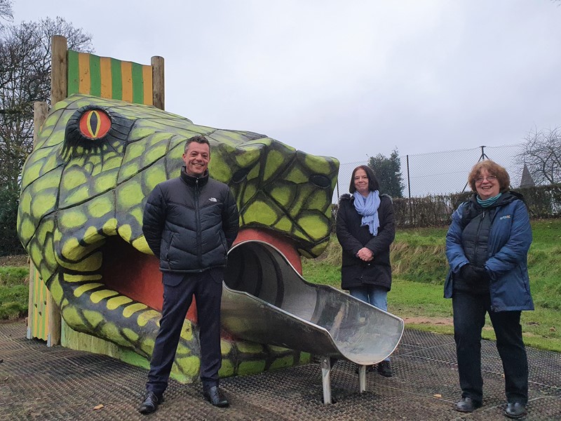 Councillor Bob Johnson, Councillor Mary Lea and Christine Welburn stand next to snake head slide at Hillsborough playground