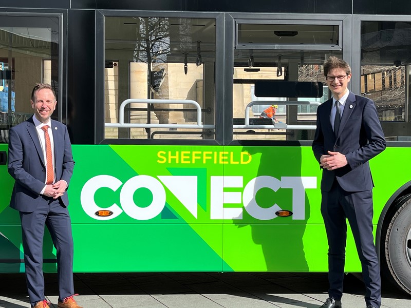 Cllr Ben Miskell and Cllr Tom Hunt standing in front of a green Sheffield Connect fully electric bus